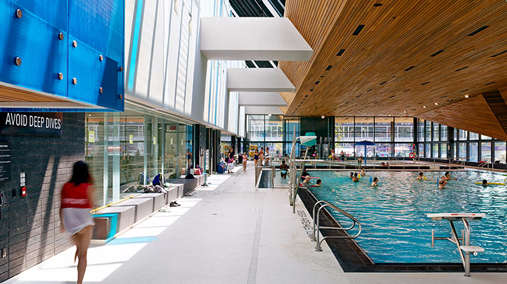 People swimming in the idoor lap/leisure pool at the Regent Park Aquatic Centre